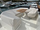 Looking forward on the Flybridge towards the seating with table and Helm postition